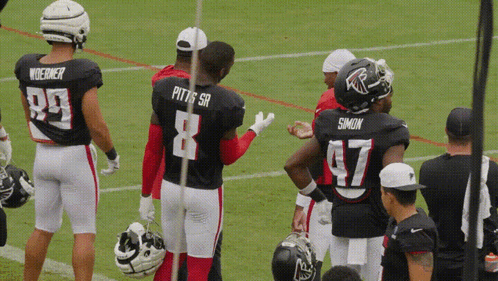 Football Players Pitts Sr and Simon on Field