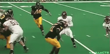 Football Players Playing on Green Field