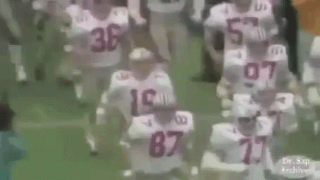Football Players Running on Field