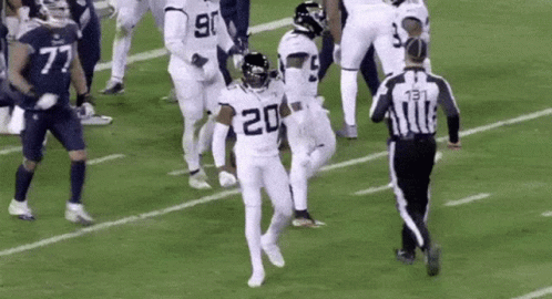 Football Players Running With Referee