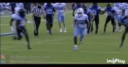Football Players Running With Referee Watching