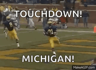 Football Players Running With Touchdown Michigan