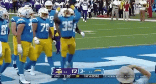Football Players Walking On Field During Game GIF
