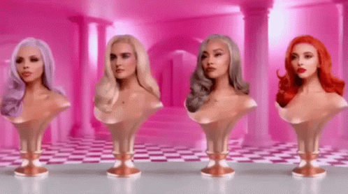 Four Busts Of Women With Different Hair Colors Are Lined Up In A Row On A Table . GIF