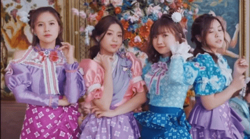 Four Girls Posing for Picture in Front of Painting