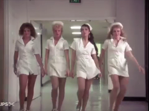 Four Nurses Walking Down Hospital Hallway