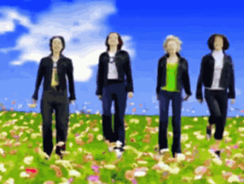 Four People Walking in Flower Field Blue Sky