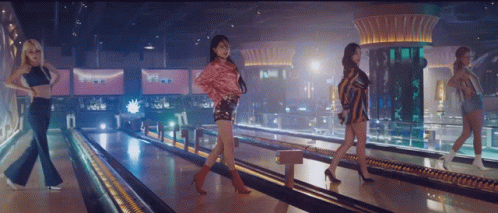 Four Women Are Walking Down A Bowling Alley GIF