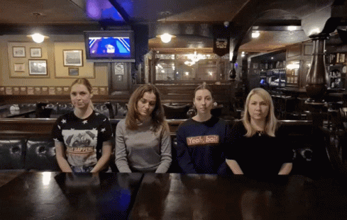 Four Women at Table One Wearing Yeah/Ball Shirt