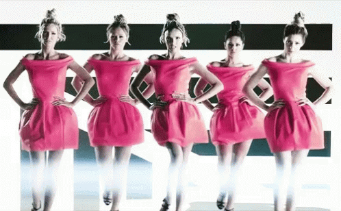 Four Women In Pink Dresses Are Standing Next To Each Other GIF