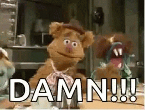 Fozzie Bear From The Muppet Show Is Sitting At A Table And Says Damn !!! GIF
