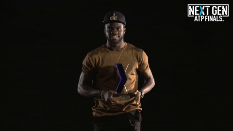 Francis Tiafoe Holding A Trophy GIF