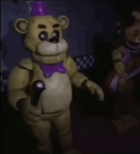 Freddy Fazbear From Five Nights At Freddy 'S Is Holding A Microphone In His Hand . GIF