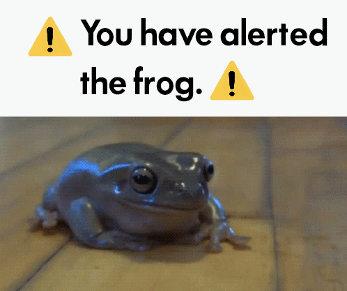 Frog Sitting Next to Alert Sign