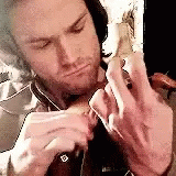 Frustrated Man Playing Worlds Smallest Violin GIF