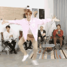 Funny Dance In Front Of Seated Friends GIF