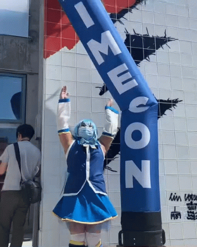 Funny Girl Dancing With Inflatable Tube Man GIF