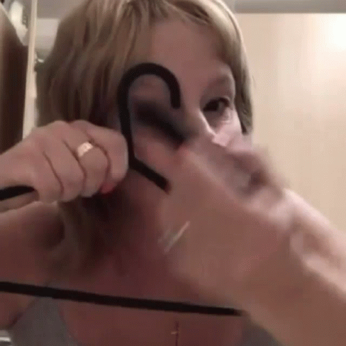 Funny Grandma Tracing Eyebrows In Clothes Hanger GIF