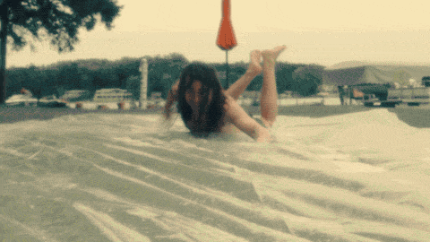 Funny Lady Drifting Away From Waterslide GIF