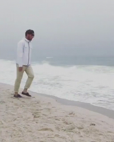 Funny Man Disappearing On Beach Sand GIF
