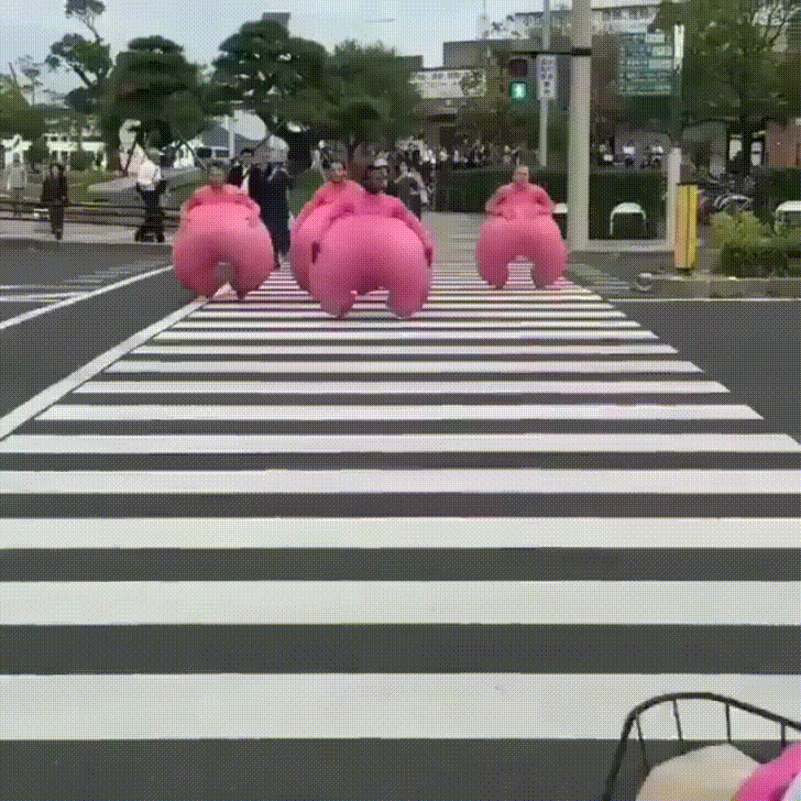 Funny Pink Inflatable Pants Jumping On Streets GIF