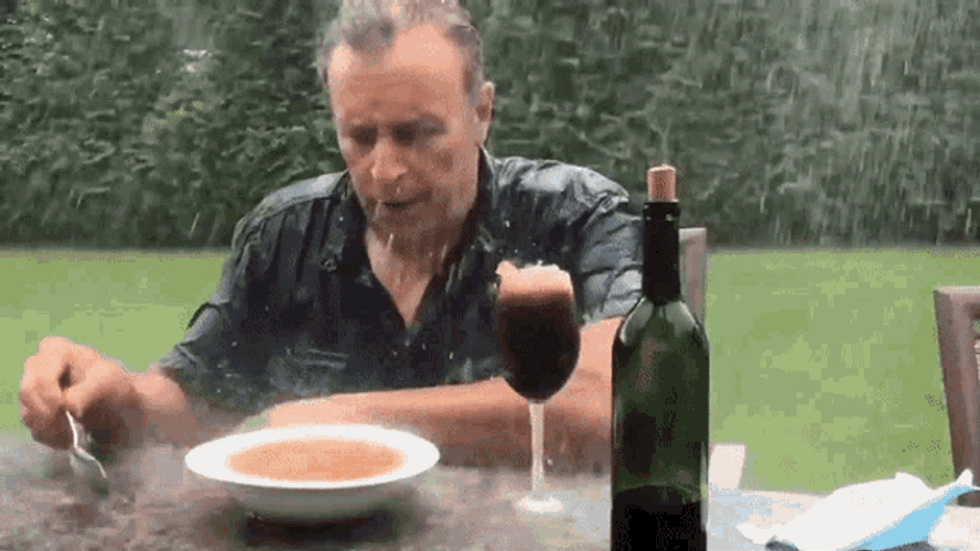 Funny Rain Unbothered Man Eating GIF