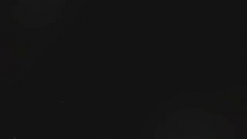 Gal Surrounded by Smoke in Dark Room