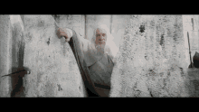 Gandalf Looking Behind The Rock GIF