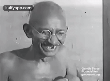 Gandhi Smiling In Black And White With Glasses GIF