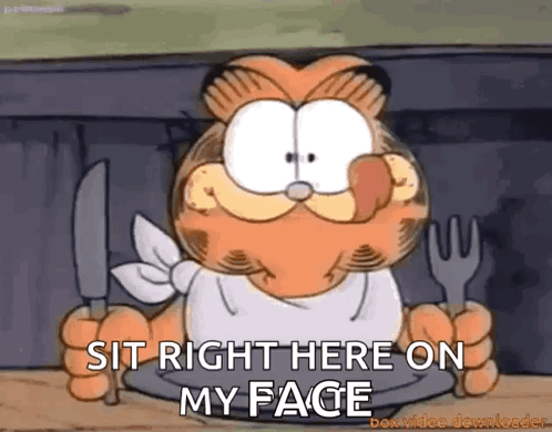 Garfield Sitting at Table Holding Knife and Fork