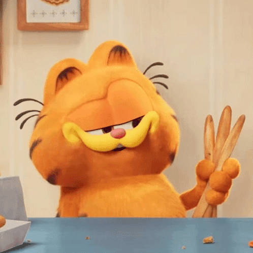 Garfield The Cat Is Sitting At A Table Holding A Pair Of Tongs . GIF