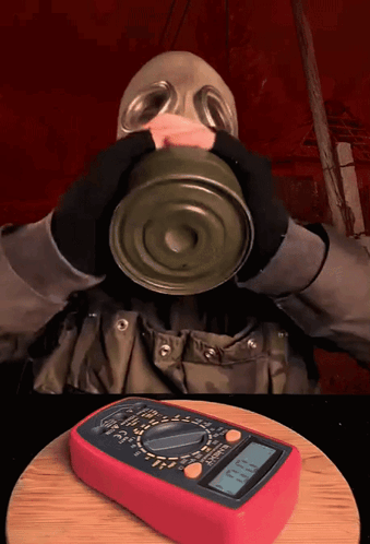 Gas Mask Man Drinking Can With Digital Multimeter GIF