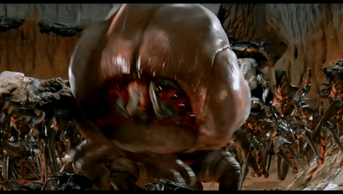 Giant Monster With Huge Mouth Surrounded By Smaller Monsters GIF