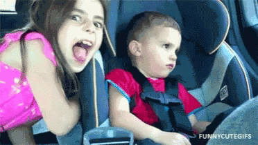 Girl and Boy Sitting in Car Seat