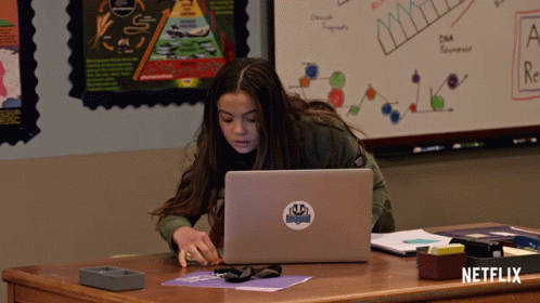 Girl at Desk With Laptop and Netflix Sticker