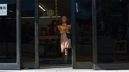 Girl Carrying Stack of Books in Front of Turkey Store 8 Cents