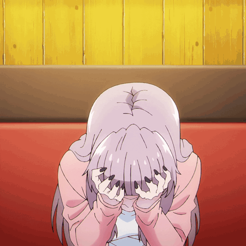 Girl Covering Face In Front Of Yellow Wooden Wall GIF