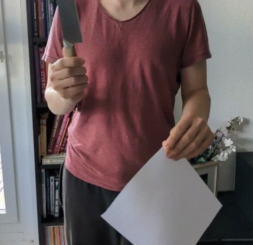 Girl Cutting Paper Using Sharp Knife GIF