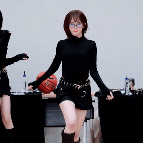 Girl Dancing in Front of Basketball Saying Elite
