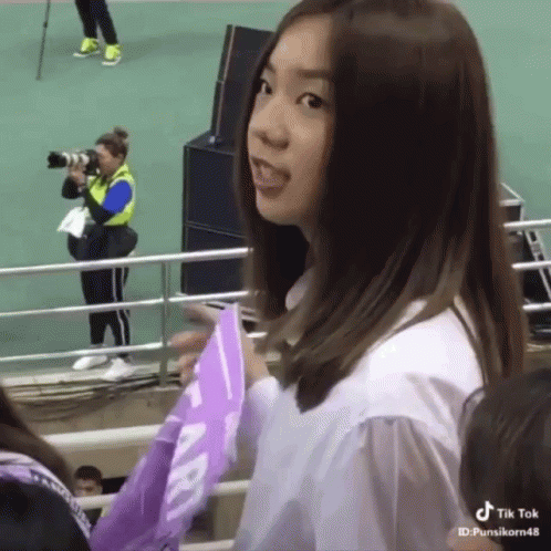 Girl Holding Purple Flag Sticking Tongue Out