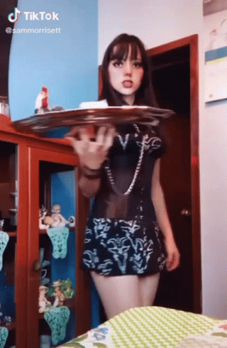 Girl In Black Dress Holding Tray GIF