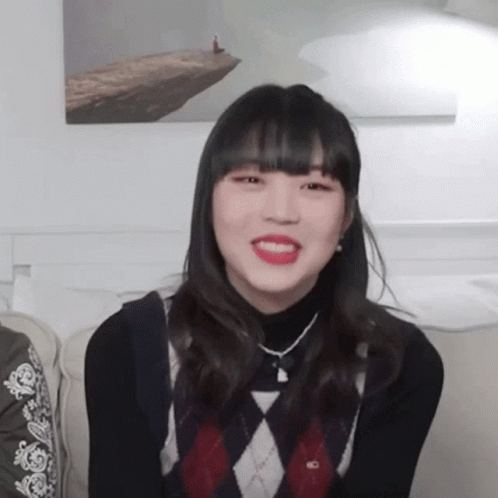Girl In Black Turtleneck And Plaid Sweater Smiling GIF