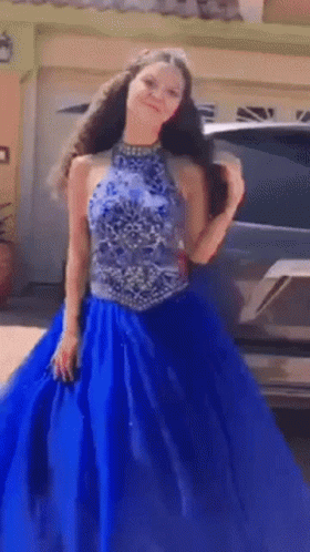 Girl in Blue Dress in Front of Car