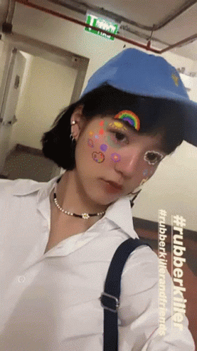 Girl in Blue Hat White Shirt With Rainbow on Face