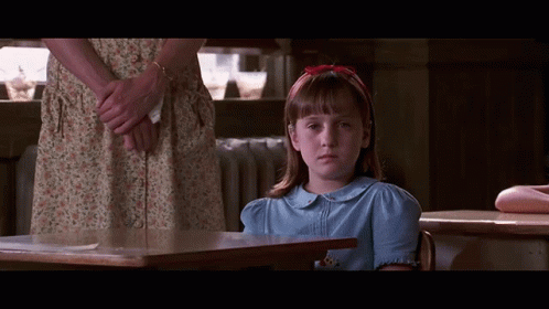 Girl in Blue Shirt at Desk