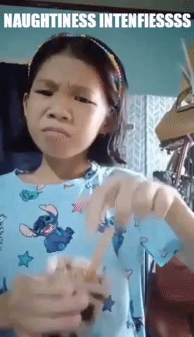 Girl in Blue Shirt Holding Cup Making Face