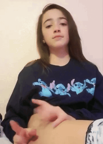 Girl in Blue Stitch Sweatshirt Touching Belly