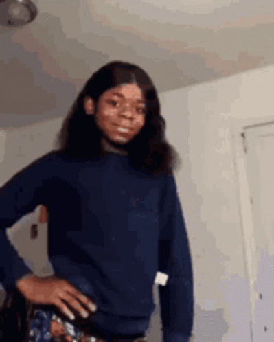 Girl in Blue Sweater Standing with Hands on Hips