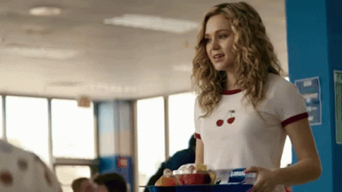 Girl in Cherry Shirt Holding Tray of Food