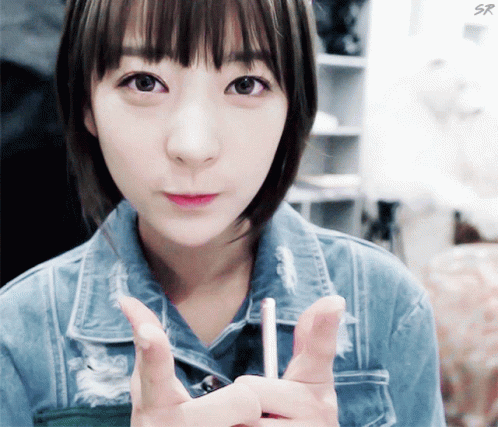Girl In Denim Jacket Holding Lollipop GIF